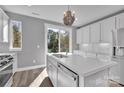 Bright kitchen featuring white cabinets, quartz countertops, and modern fixtures at 582 West End Dr, Charlotte, NC 28208