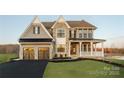 Charming home with a covered porch, two-car garage, and meticulously maintained landscaping at Lot 47 Watercourse Way # Devonshire, Belmont, NC 28012