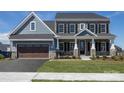 Two-story house with blue and stone siding, two-car garage, and front porch at Lot 51 Watercourse Way # Nottingham, Belmont, NC 28012
