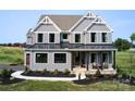 Stately two-story home displaying gray siding, black trim, a welcoming porch, and a convenient two-car garage at Lot 51 Watercourse Way # Covington, Belmont, NC 28012