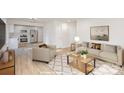 Bright living room showcasing an open floor plan connecting to a modern kitchen with stainless steel appliances at 429 Dare Dr, Charlotte, NC 28206