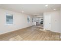 Open concept living and kitchen area with hardwood floors and an abundance of natural light at 429 Dare Dr, Charlotte, NC 28206