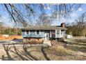 Charming blue house featuring brick accents and a spacious yard at 5034 Clearwater Lake Rd, Mount Holly, NC 28120