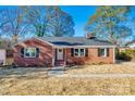 Brick ranch house with dark shutters, landscaping, and a covered entry at 1081 Evergreen Cir, Rock Hill, SC 29732