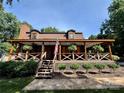 Inviting two-story home with a cozy covered porch and manicured landscaping at 13538 Pine Harbor Rd, Charlotte, NC 28278