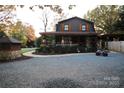 Attractive two-story home featuring a covered porch and a spacious gravel driveway at 13538 Pine Harbor Rd, Charlotte, NC 28278