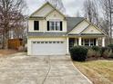 Two-story house with a large driveway and landscaping at 141 Byers Rd, Troutman, NC 28166