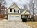 Two-story house with a large driveway and landscaping at 141 Byers Rd, Troutman, NC 28166