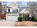 Charming two-story home with a well-maintained lawn and two-car garage at 141 Byers Rd, Troutman, NC 28166