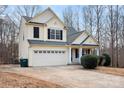 Two-story home featuring a two-car garage, well-kept lawn, and traditional architecture at 141 Byers Rd, Troutman, NC 28166