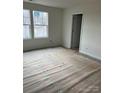 Unfinished bedroom with new flooring and large windows at 164 Wildwood Loop, Statesville, NC 28677