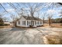 Charming white house with gray trim and a gravel driveway at 317 W Main St, Marshville, NC 28103