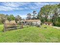 Property featuring a spacious yard with a wooden fence and a storage shed at 335 Ridgewood Dr, Mt Ulla, NC 28125