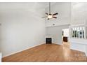 Bright living room with vaulted ceiling, fireplace, and wood floors, providing a comfortable and spacious area at 14922 Deshler Ct, Charlotte, NC 28273