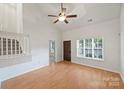 Inviting living room with hardwood floors, staircase, and large window allowing natural light to fill the space at 14922 Deshler Ct, Charlotte, NC 28273
