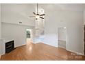 Spacious living room featuring a fireplace, wood floors, and a staircase, offering an open and airy feel at 14922 Deshler Ct, Charlotte, NC 28273