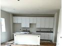 Modern kitchen featuring white cabinets, granite countertops, and an island at 168 Wildwood Loop, Statesville, NC 28625
