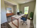 Bright home office features a large desk, neutral rug, and modern furnishings at 168 Wildwood Loop, Statesville, NC 28625