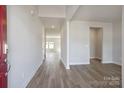 Spacious foyer with light gray wood floors, leading to an open-concept living area at 109 Obadiah Ct, Troutman, NC 28115