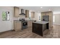 The kitchen features stainless steel appliances, granite countertops, a kitchen island, and wood-look vinyl floors at 1100 Turkey Creek Ridge Rd, York, SC 29745