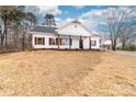 Inviting home with traditional details, showcasing white siding, dark shutters, and a well-maintained lawn at 1300 Eddie St, Gastonia, NC 28054