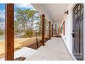 Covered front porch featuring sturdy wooden columns and a view of the landscaped yard at 1300 Eddie St, Gastonia, NC 28054