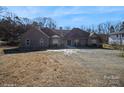 Brick house with a large driveway and mature trees at 1808 Wilton Gate Dr, Charlotte, NC 28262