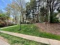 Lush green front lawn, accented by mature trees, provides a picturesque setting for the property at 21315 Blakely Shores Dr, Cornelius, NC 28031