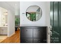 Bright entryway featuring a round mirror and sleek storage cabinet at 3302 Selwyn Farms Ln, Charlotte, NC 28209