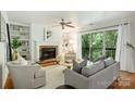 Inviting living room with fireplace, built-in bookshelves, and sliding doors to the balcony at 3302 Selwyn Farms Ln, Charlotte, NC 28209