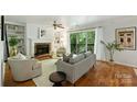 Cozy living room with a brick fireplace, built-in shelves, and access to a balcony at 3302 Selwyn Farms Ln, Charlotte, NC 28209