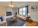 Living room with fireplace, hardwood floors, and neutral decor at 6815 Castlegate Dr, Charlotte, NC 28226