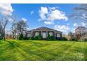 House exterior showcasing a brick facade and manicured lawn at 8420 Locksley Dr, Harrisburg, NC 28075