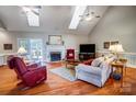 Spacious living room with hardwood floors, fireplace and vaulted ceiling at 8420 Locksley Dr, Harrisburg, NC 28075