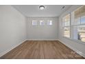 Well-lit room with wood floors, natural light, and a view of the neighborhood at 622 Amberjack Pl, York, SC 29745