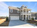 Attractive home featuring a covered porch, neutral siding, and well-maintained landscaping at 622 Amberjack Pl, York, SC 29745