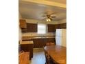 A kitchen area with a large table, refrigerator, and wooden cabinets at 805 Railroad Ave, China Grove, NC 28023