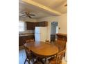 The kitchen features dark wood cabinets, a table with chairs, and an adjacent utility area at 805 Railroad Ave, China Grove, NC 28023