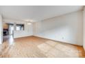 A light and airy living room with hardwood floors, a chandelier, and clear sight lines into the adjacent dining area at 8218 Legare Ct, Charlotte, NC 28210