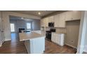 Modern kitchen with white cabinets, granite countertops, an island, and stainless steel appliances at 159 Ella Claire Dr, York, SC 29745