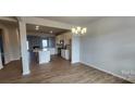 Open kitchen and dining area with an island, stainless appliances, and wood flooring at 159 Ella Claire Dr, York, SC 29745
