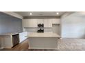 Bright kitchen with white cabinets, granite countertops, stainless steel appliances, and large kitchen island at 159 Ella Claire Dr, York, SC 29745