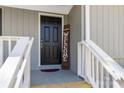 Close-up of a black front door with a welcome sign and white railings at 1637 Sumner Dr, Rock Hill, SC 29732