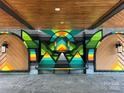 Covered common area with geometric mural and a bench for residents at 2000 Patio Ct # 129, Charlotte, NC 28205