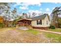 House exterior showcasing a large front yard and a spacious covered porch at 4450 Dobys Bridge Rd, Fort Mill, SC 29707