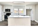 Bright kitchen featuring a large island, stainless steel appliances, and modern white cabinetry at 529 Catalina Dr, Albemarle, NC 28001