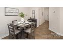 Small dining area with four chairs and a modern square table at 7109 N Mills Rd, Charlotte, NC 28216