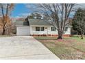 Inviting single-story home featuring green shutters, a welcoming front porch, and an attached garage at 161 Westscott Dr, Statesville, NC 28625