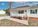 Charming front porch with white railing, steps, and green shutters highlighting the home's exterior at 161 Westscott Dr, Statesville, NC 28625