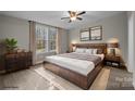 Stylish bedroom with a ceiling fan, natural light and neutral tones creating a tranquil retreat at 2029 Big Dipper Dr, Clover, SC 29710